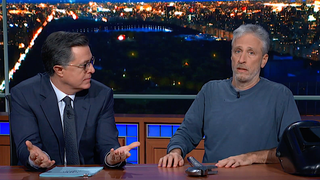 Jon Stewart premieres his new movie <i>Irresistible</i> from under Stephen Colbert's desk